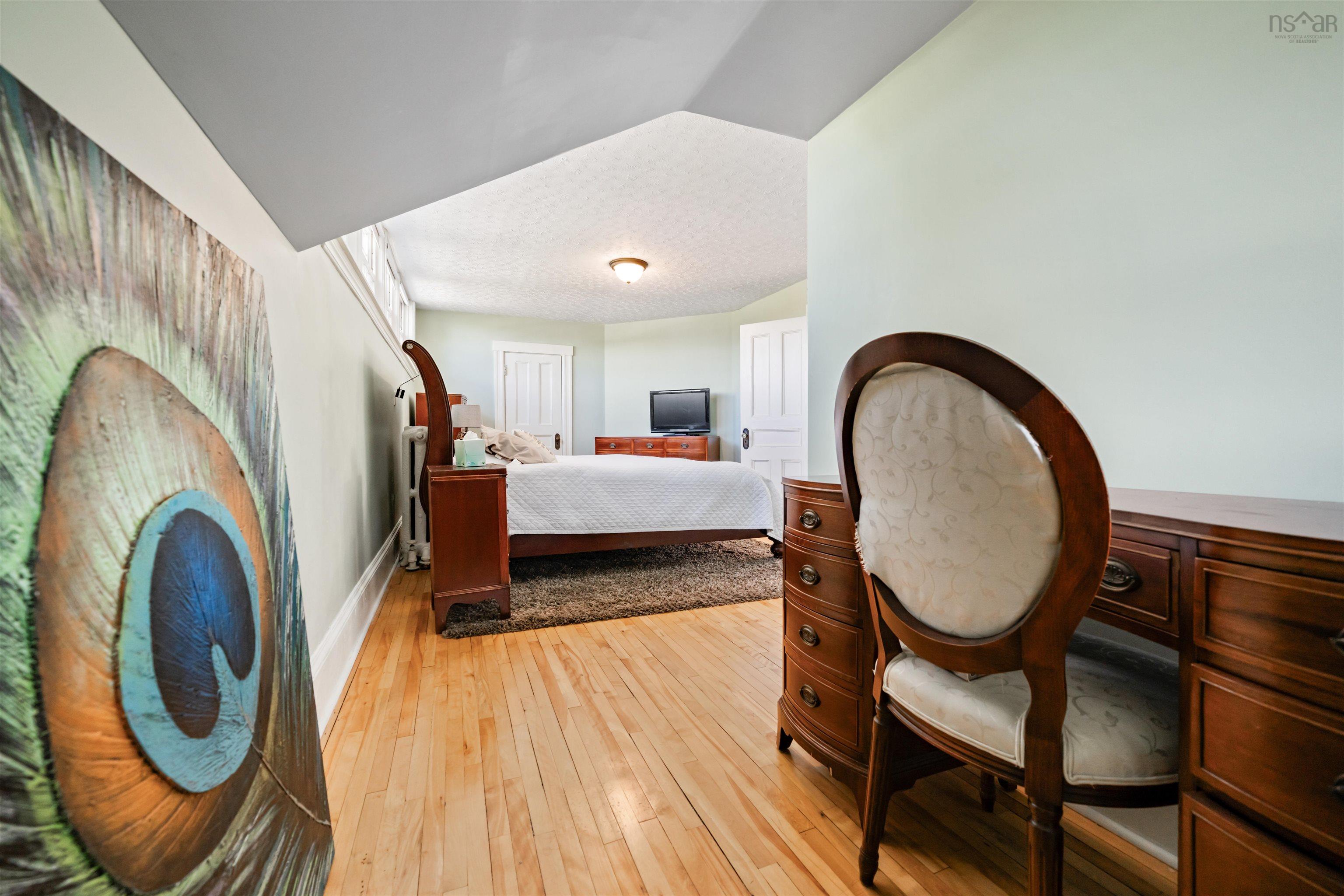 Bedroom featuring light wood finished floors and a textured ceiling