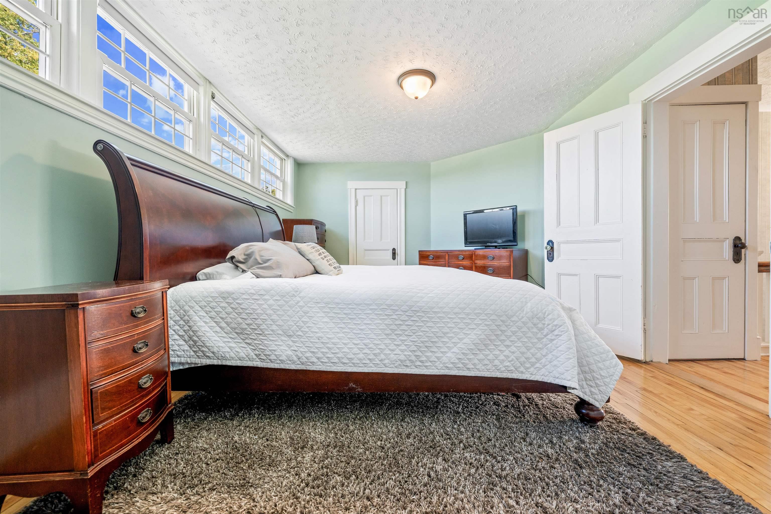 Bedroom featuring a textured ceiling and wood finished floors