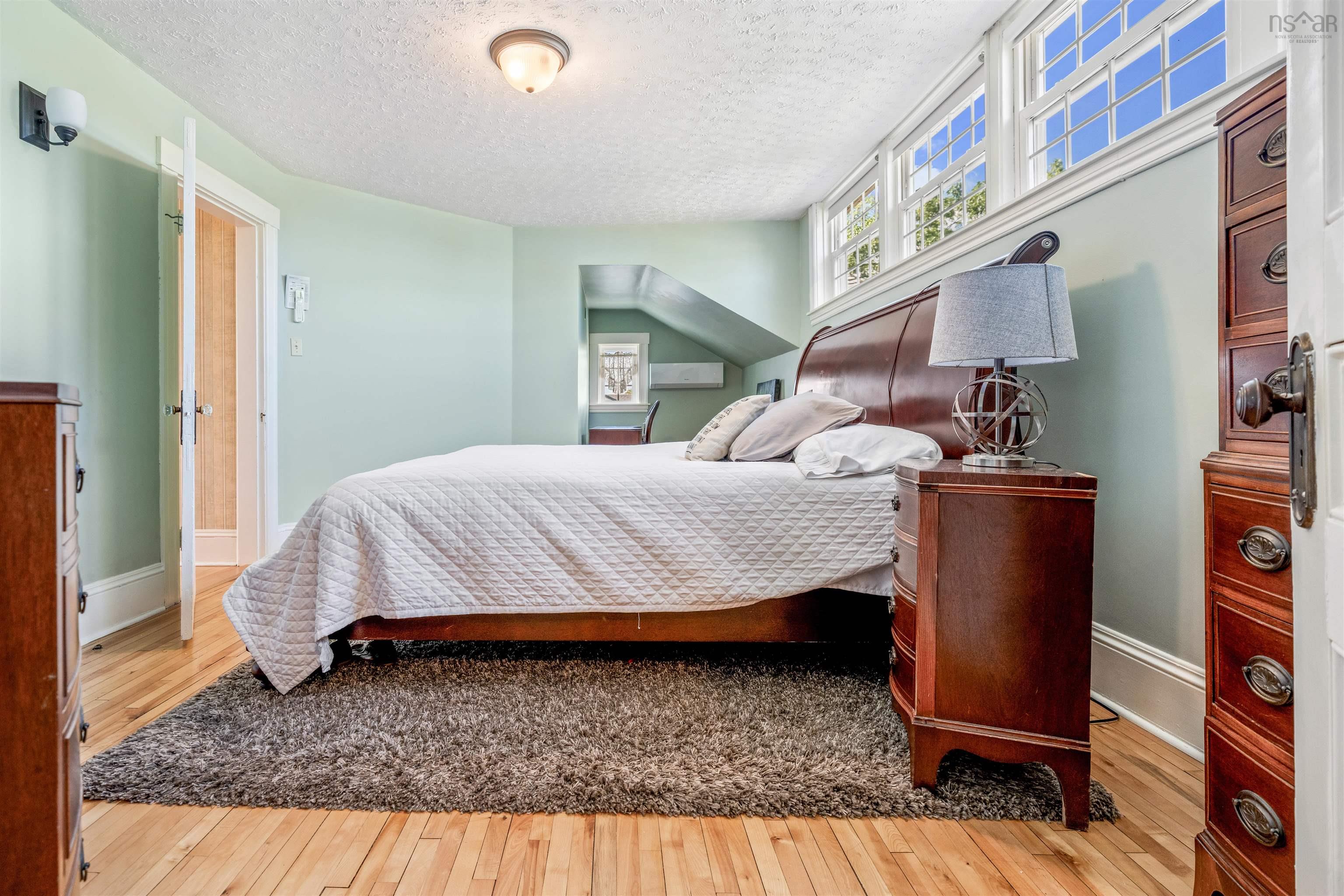 Bedroom with light wood-style flooring and a textured ceiling