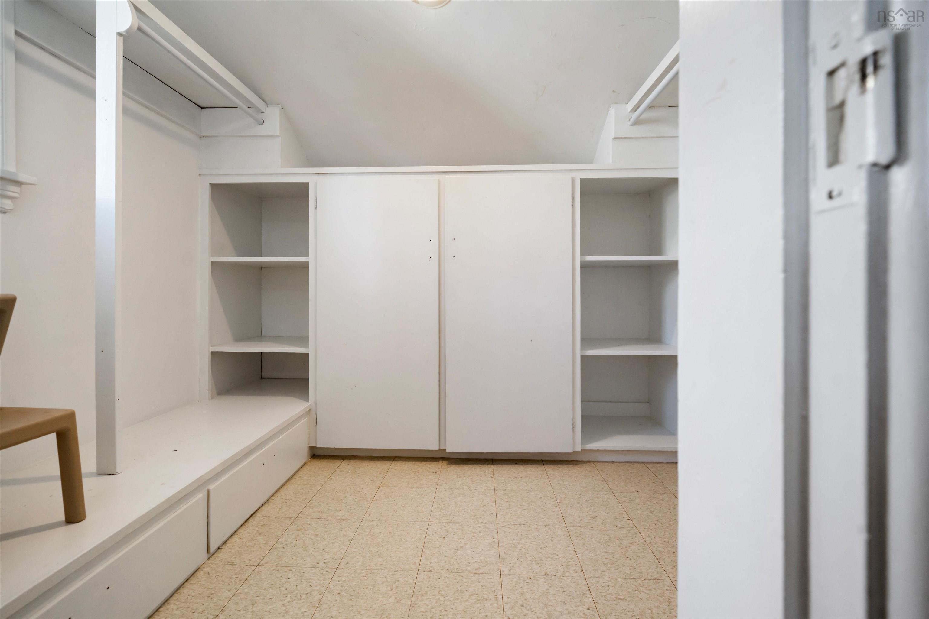 Walk in closet with light floors