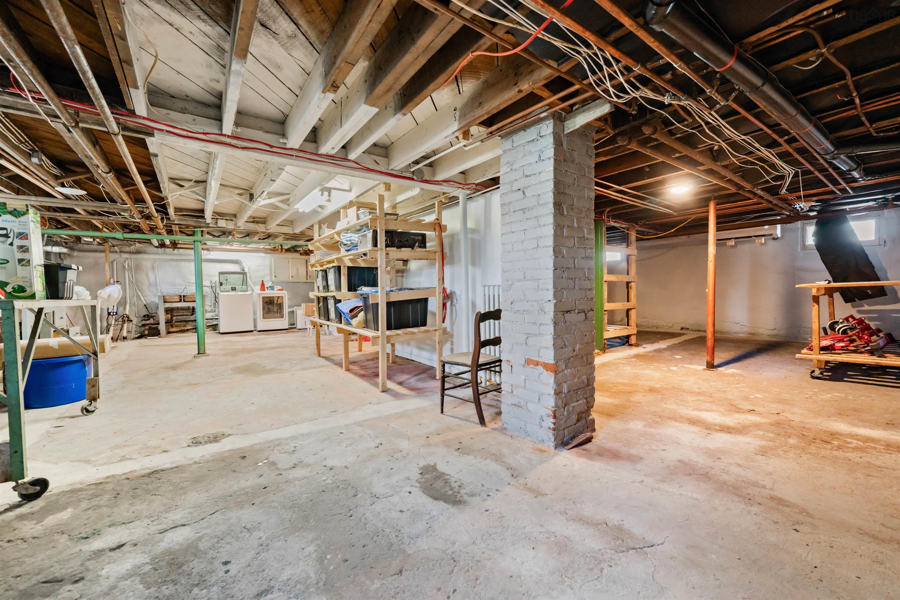 Unfinished basement featuring washer / dryer
