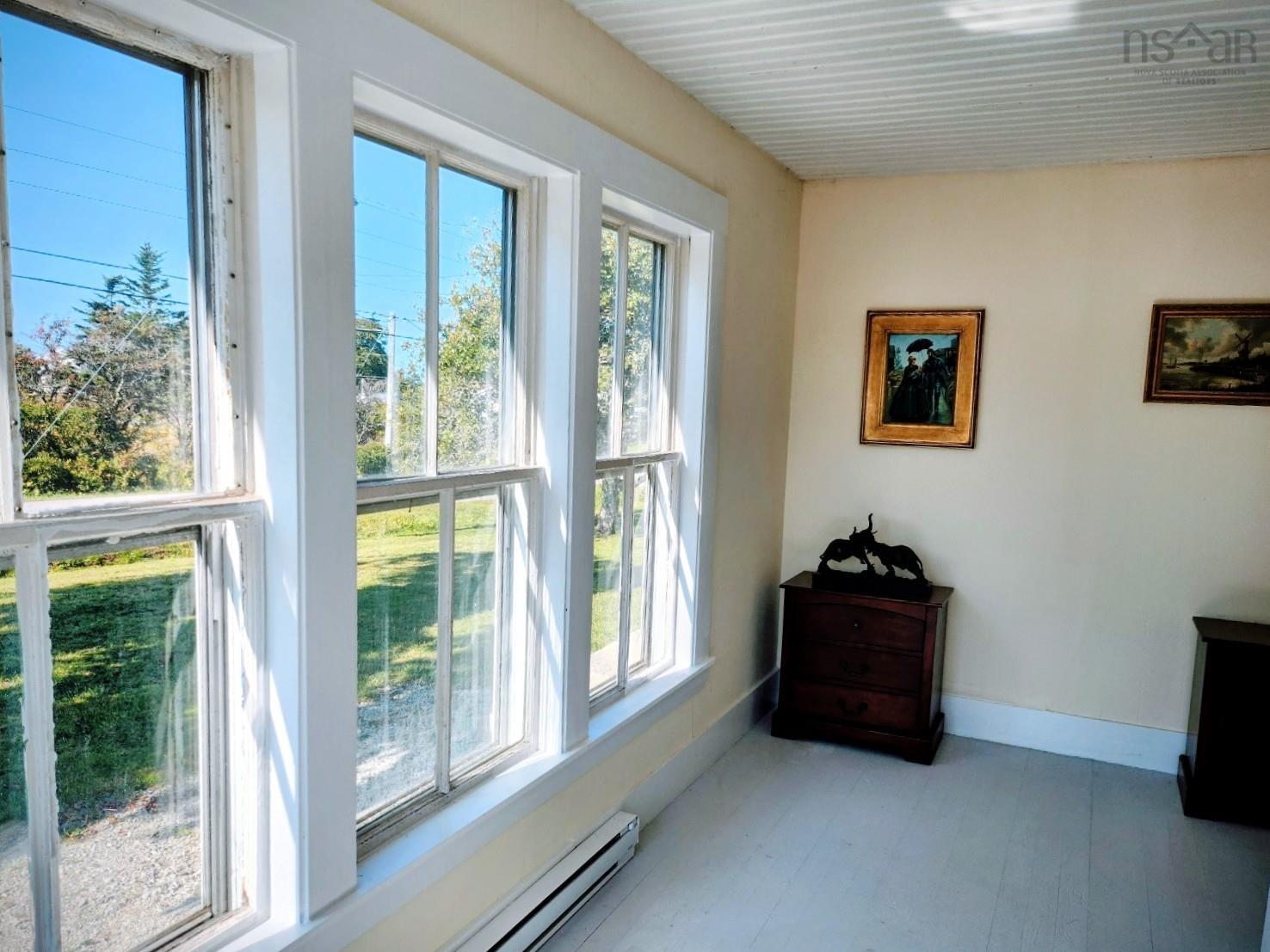 Entryway featuring a baseboard heating unit and tile patterned floors