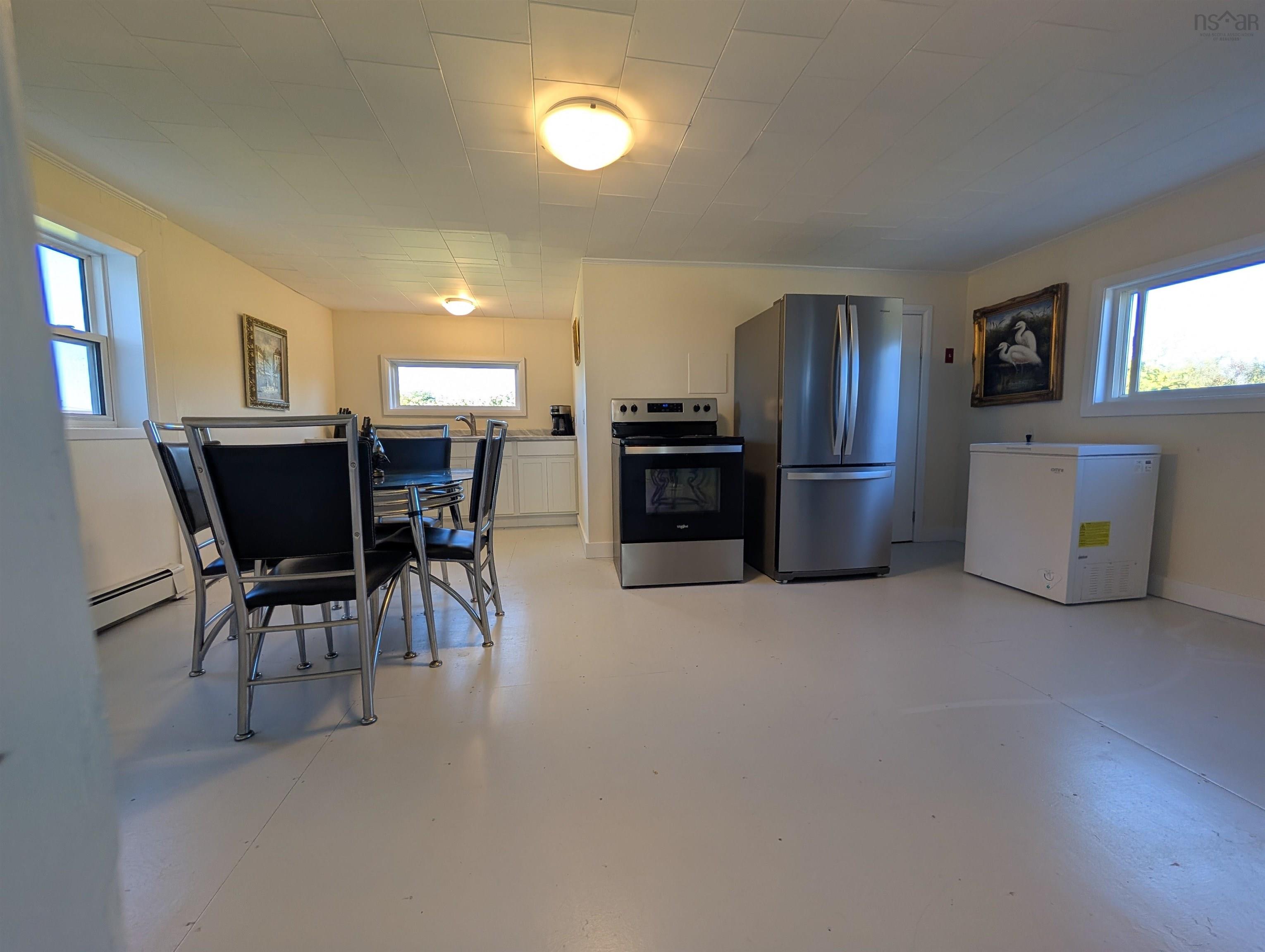 Kitchen featuring appliances with stainless steel finishes, white cabinetry, and healthy amount of natural light