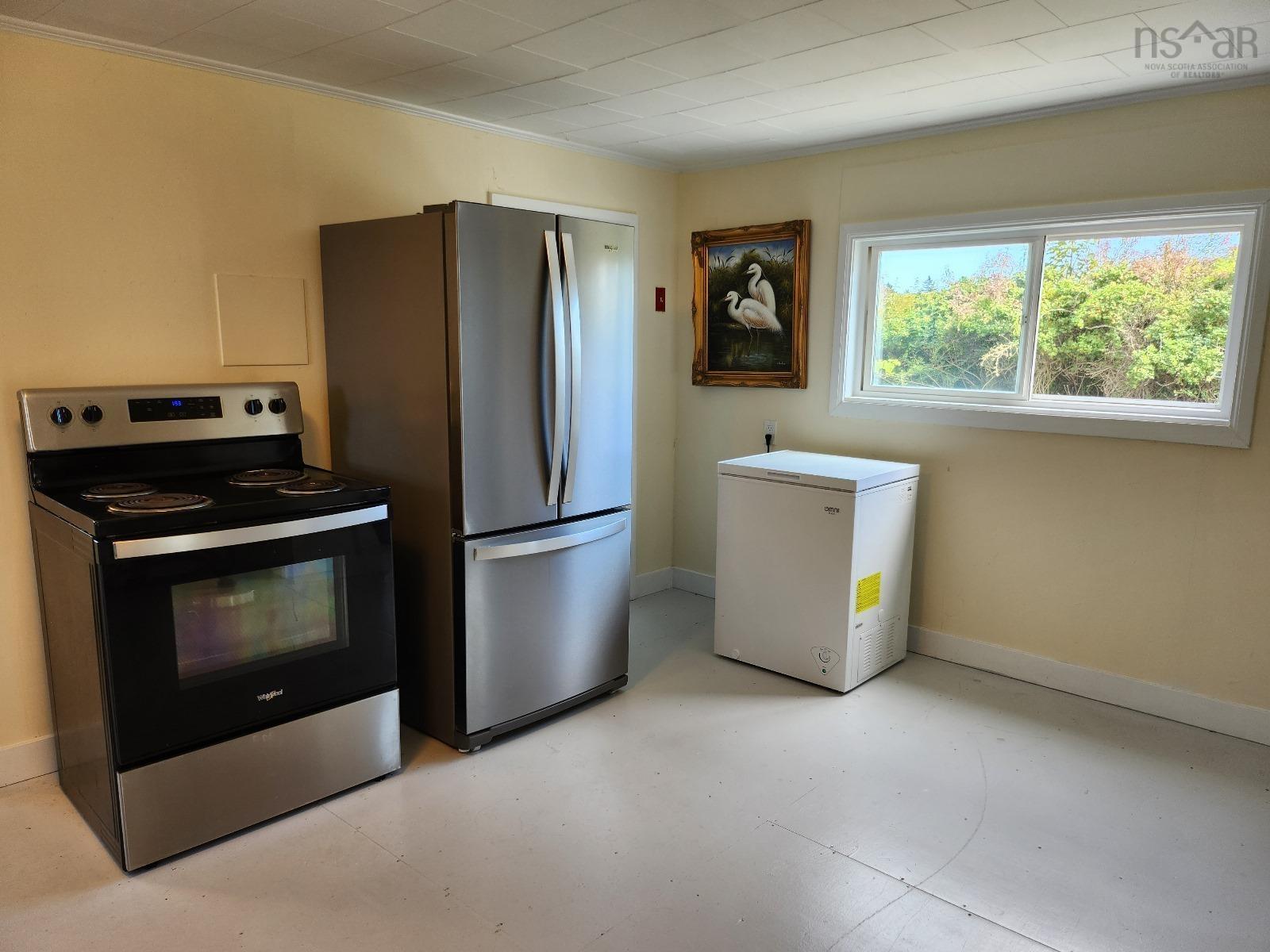 Kitchen featuring stainless steel appliances and ornamental molding