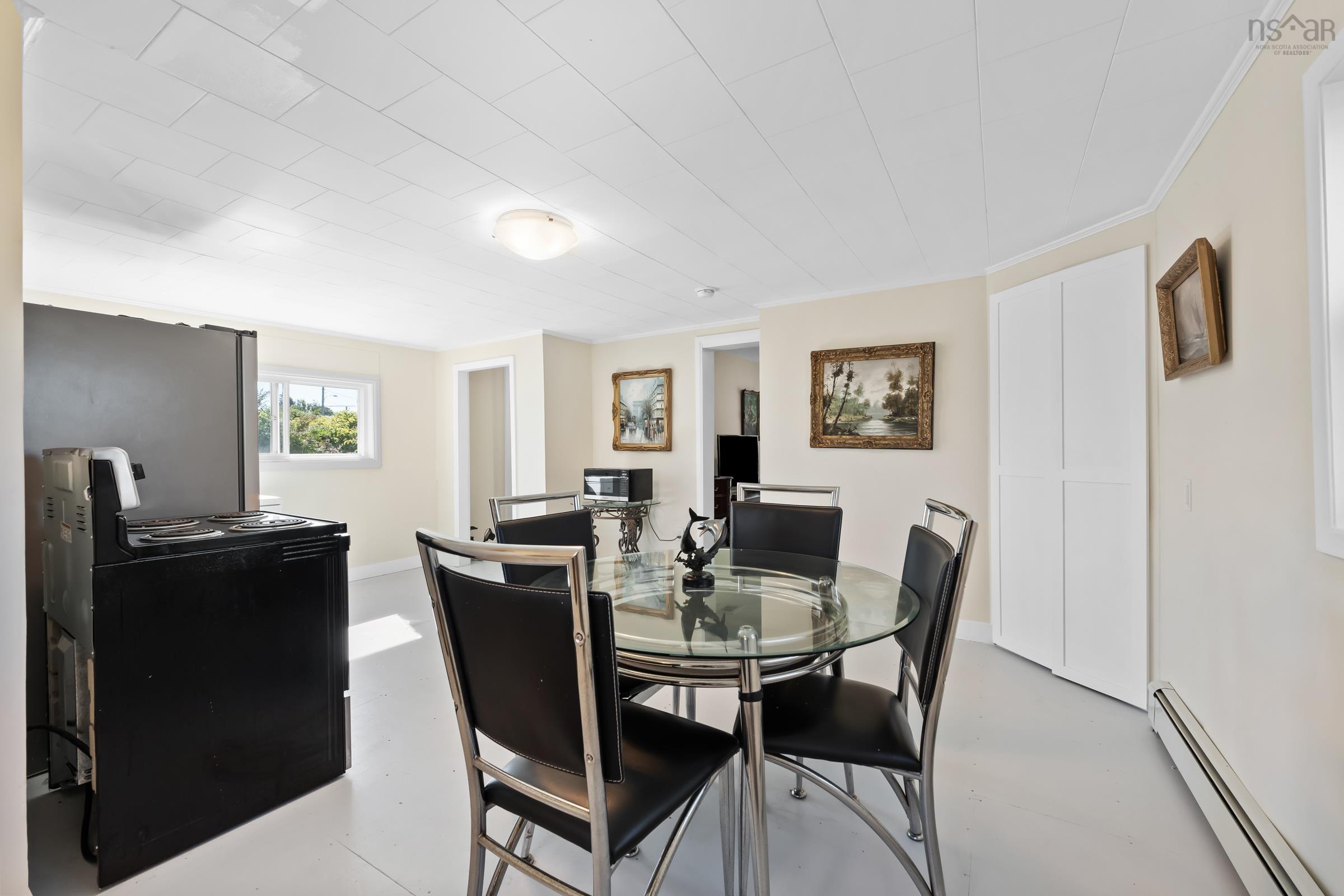Dining room featuring a baseboard radiator, finished concrete floors, and ornamental molding