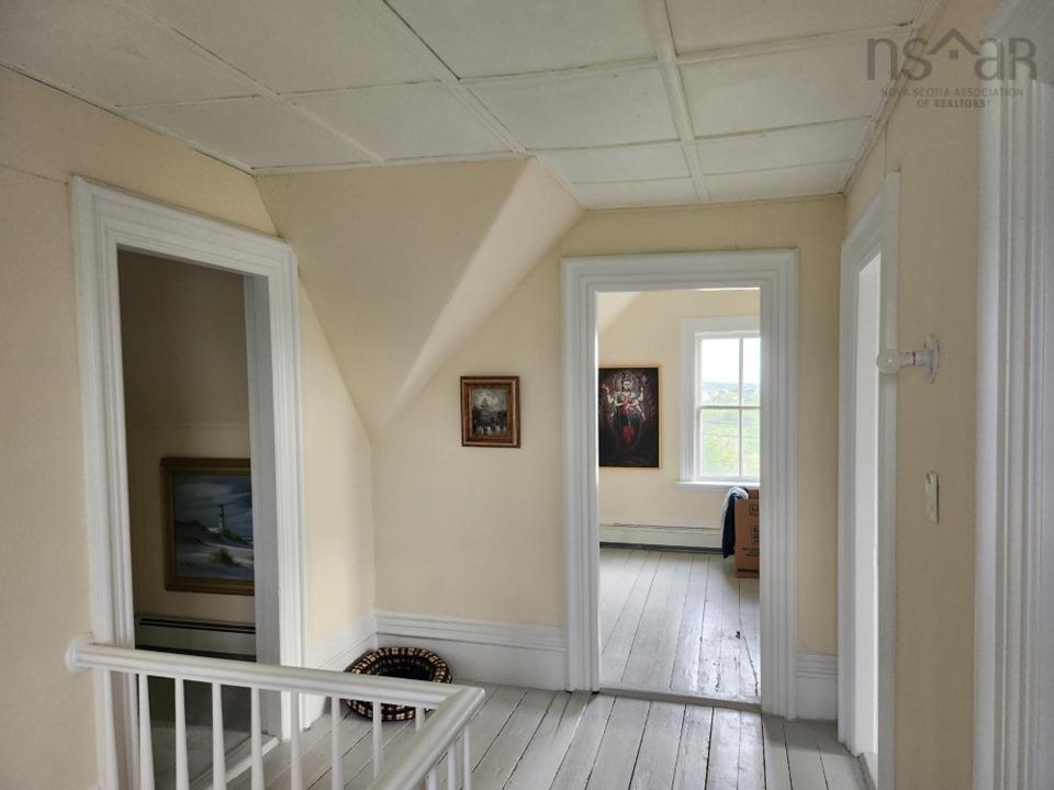 Corridor featuring light wood-style flooring and a baseboard radiator