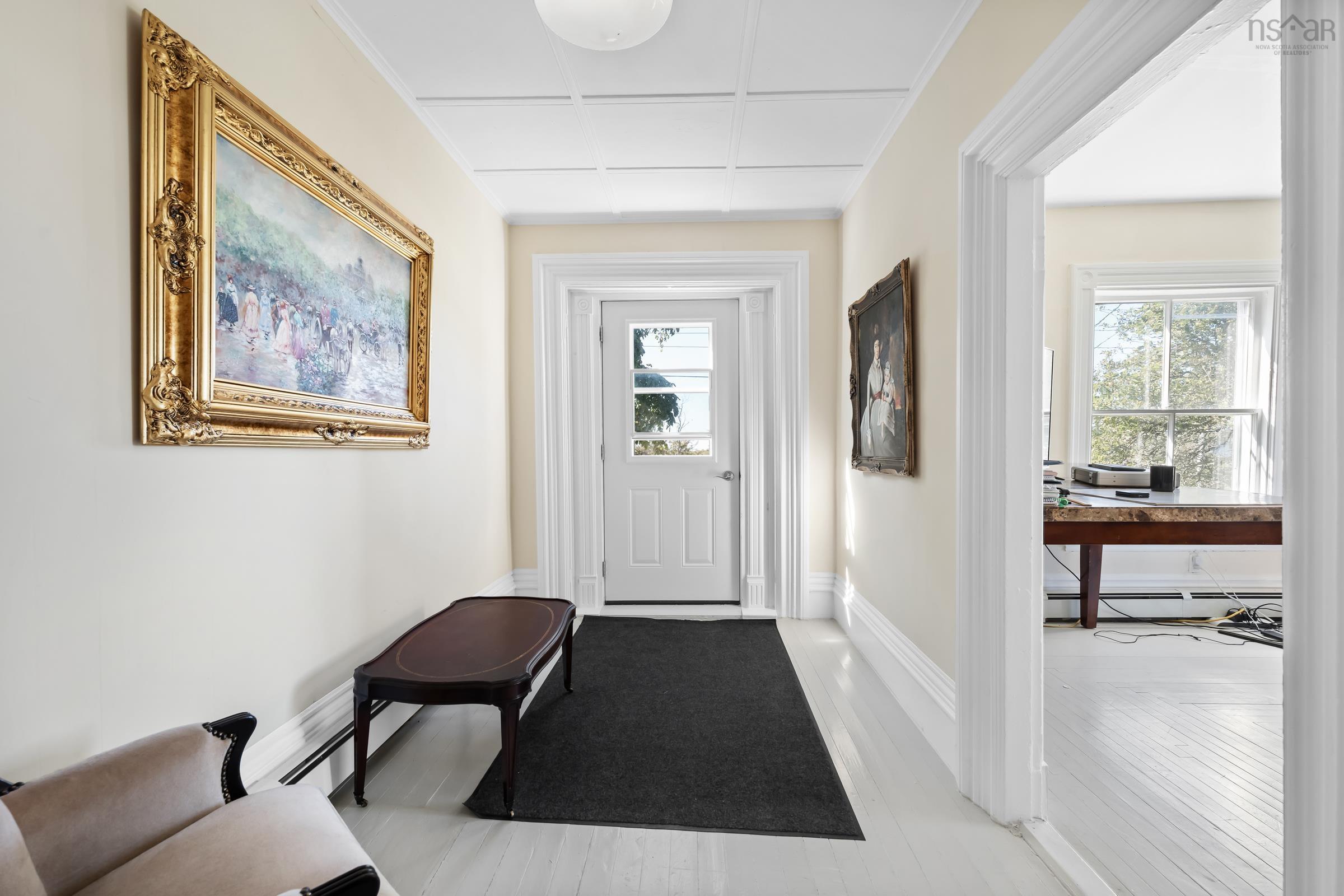 Entryway featuring a desk and a baseboard heating unit