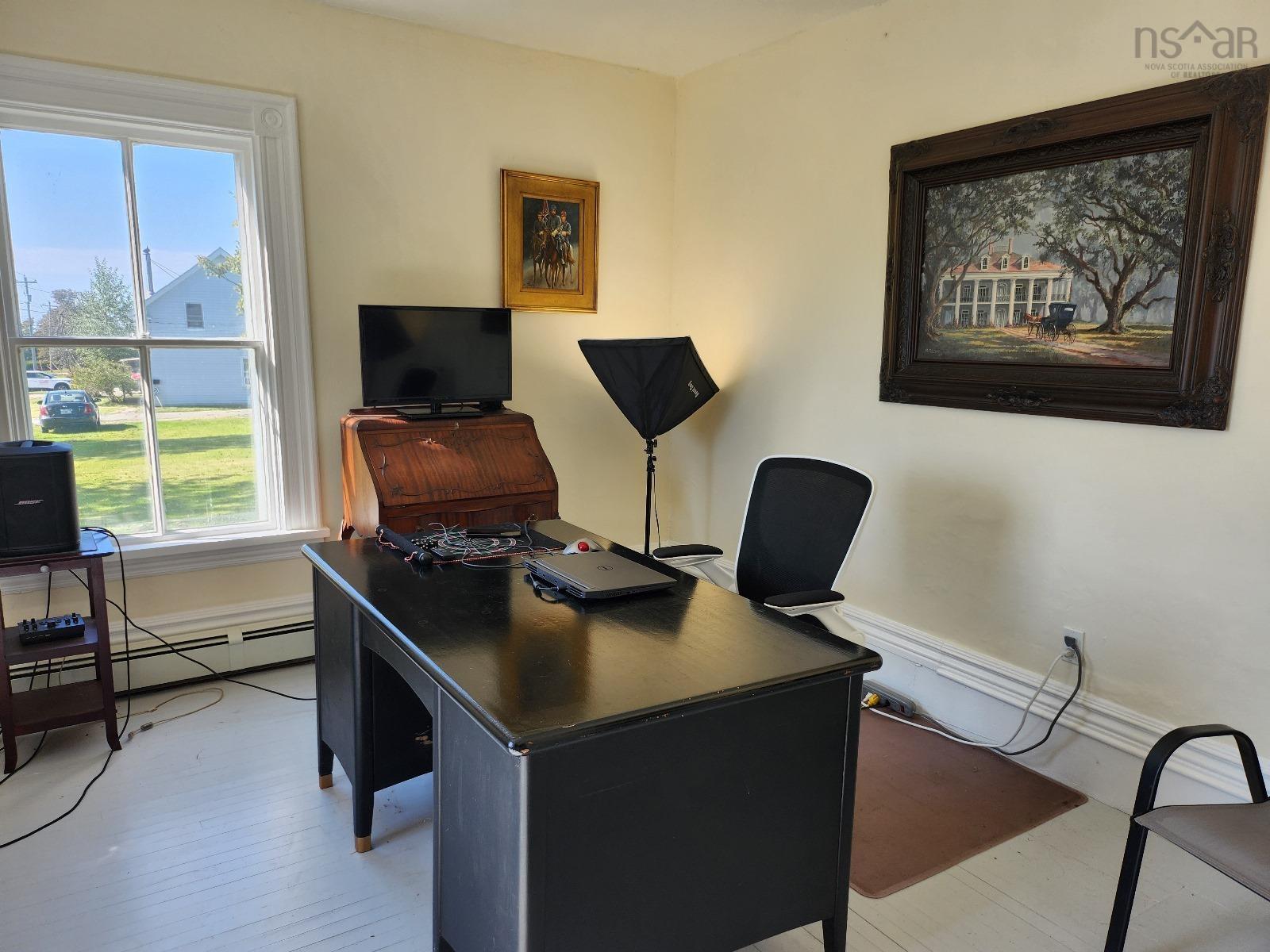 Office space featuring light wood-style floors and baseboard heating