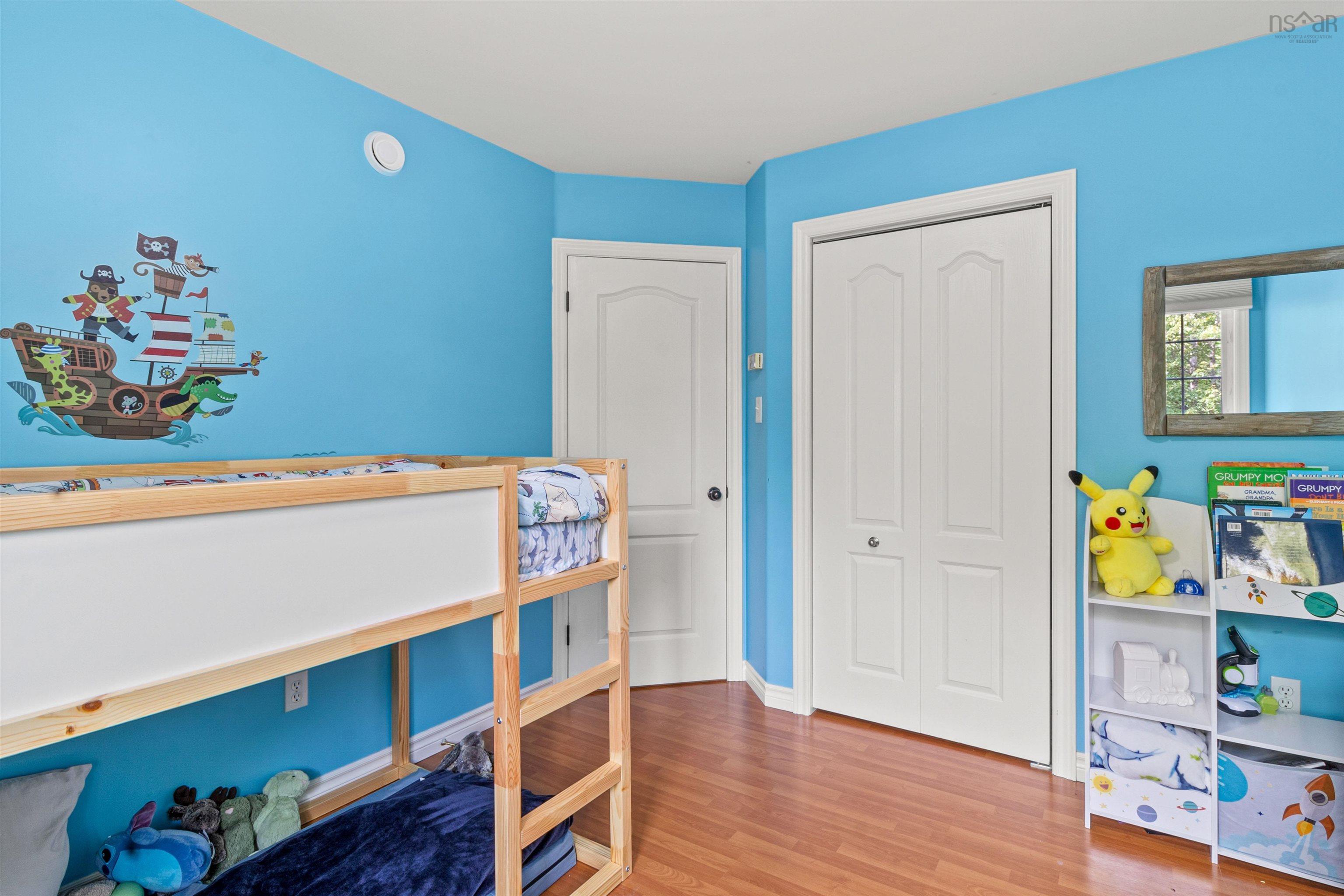 Bedroom with light wood finished floors and a closet